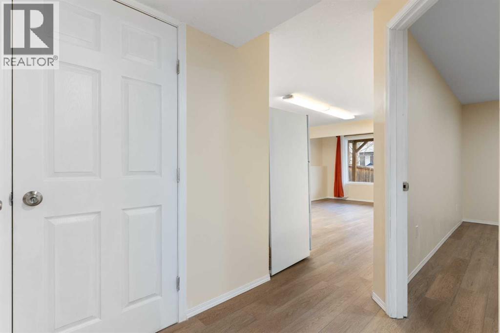 Lower-level hallway, door to utility room - 129 Evansbrooke Way Nw, Calgary, AB - Indoor Photo Showing Other Room