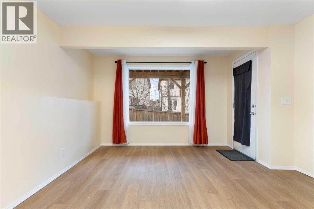 Lower-level living/recreation room, door to patio - 129 Evansbrooke Way Nw, Calgary, AB - Indoor Photo Showing Other Room