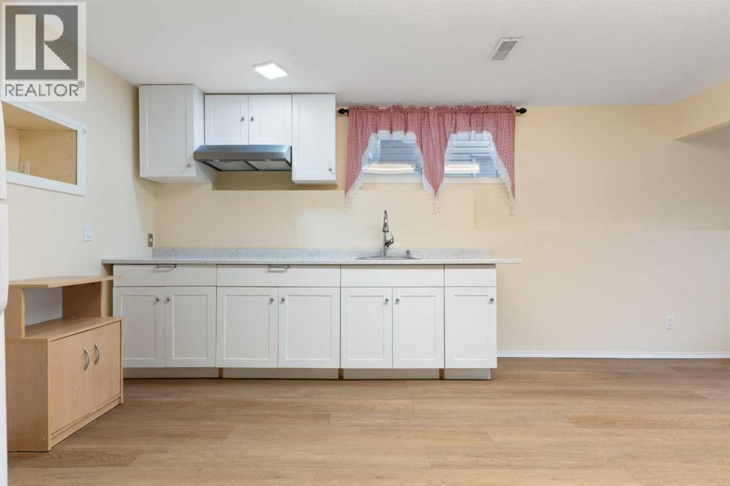 Kitchenette, eating area, cupboards, sink, hood fan - 129 Evansbrooke Way Nw, Calgary, AB - Indoor