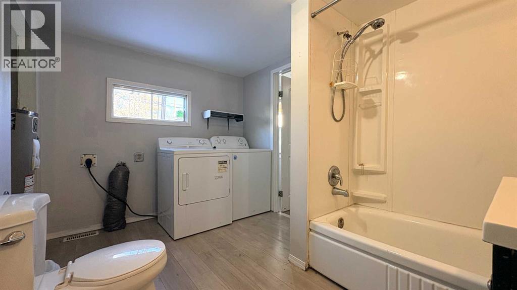 Bathroom/Laundry combo! - 622 5 Avenue, Wainwright, AB - Indoor Photo Showing Laundry Room