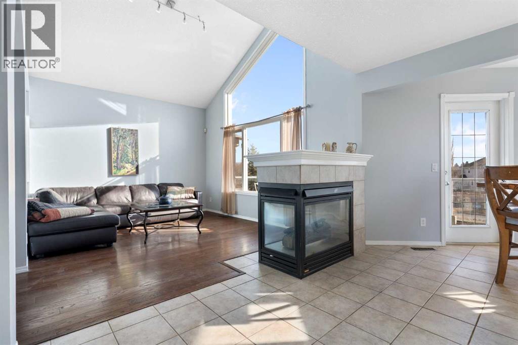 202 Schooner Close Nw, Calgary, AB - Indoor Photo Showing Living Room With Fireplace