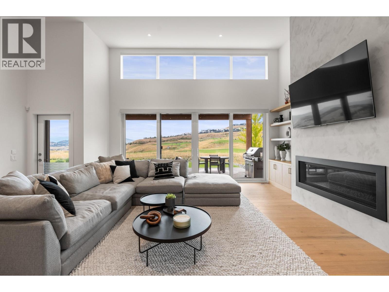 105 Predator Ridge Drive Unit# 22, Vernon, BC - Indoor Photo Showing Living Room With Fireplace