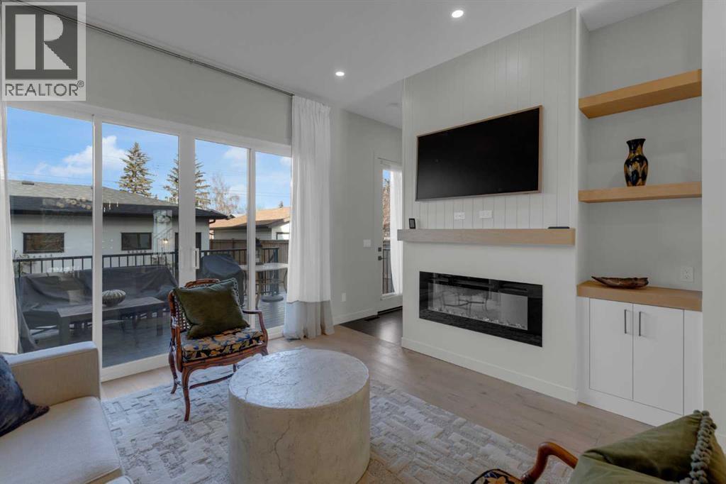7712 36 Avenue Nw, Calgary, AB - Indoor Photo Showing Living Room With Fireplace