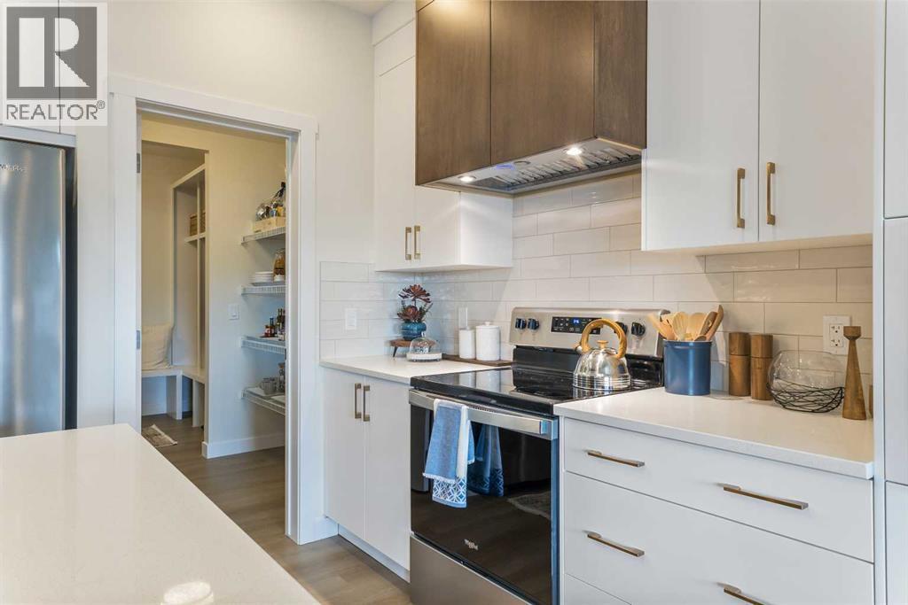 65 Emberside Grove, Cochrane, AB - Indoor Photo Showing Kitchen With Upgraded Kitchen