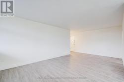 Living room with view towards entrance door. -