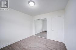 Bedroom 3 with mirrored closet door. -