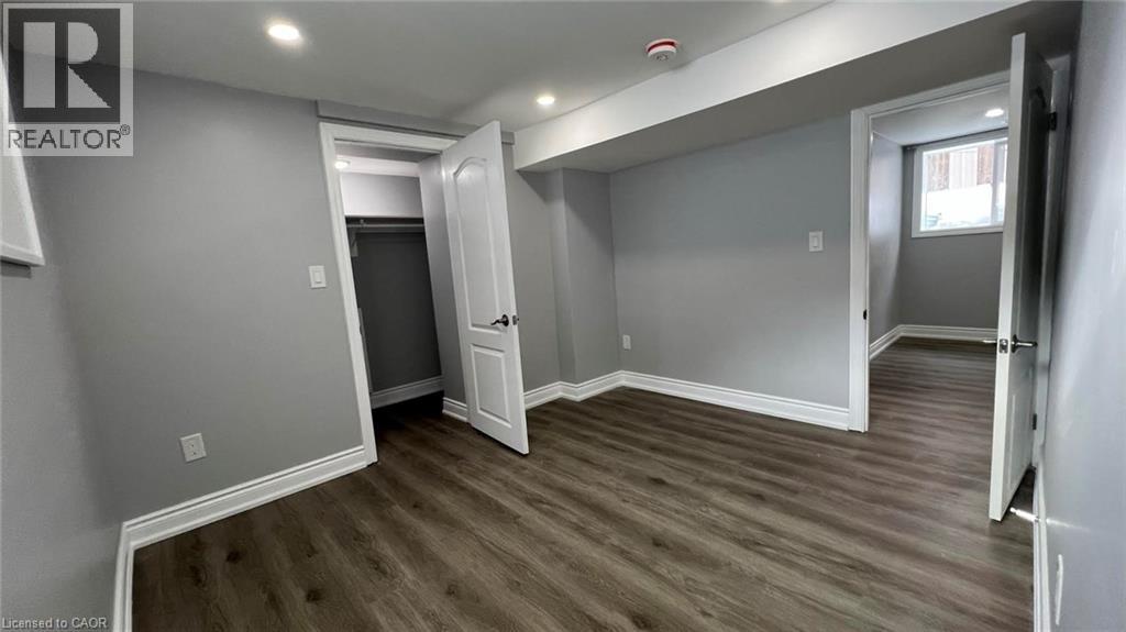Basement featuring dark wood-style floors and recessed lighting - 29 Birchcliffe Crescent Unit# 2, Hamilton, ON - Indoor Photo Showing Other Room