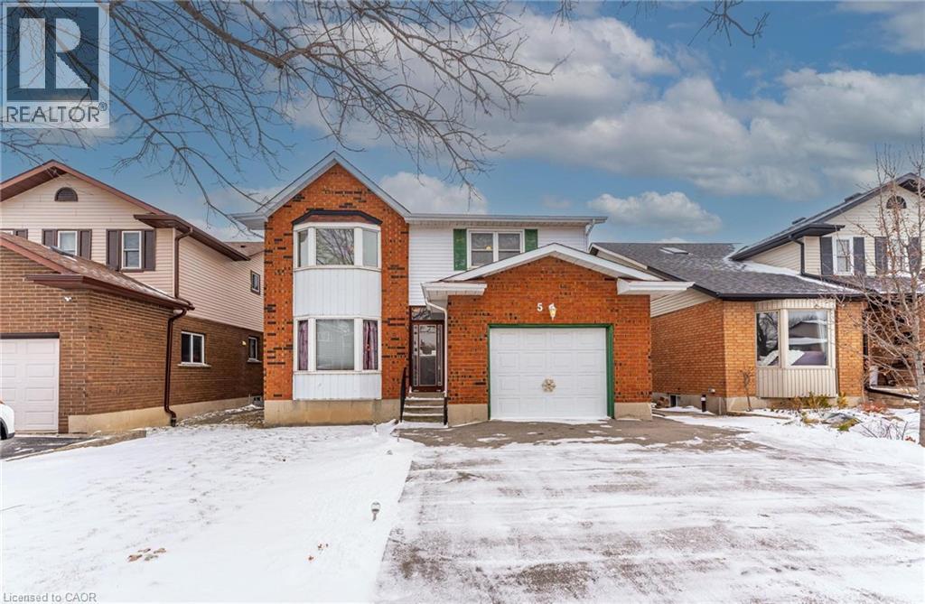 View of front facade featuring brick siding and a garage - 5 Charing Drive, Hamilton, ON - Outdoor With Facade