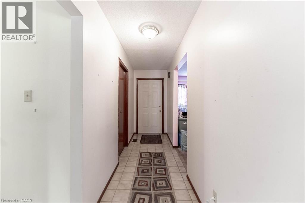 Hall with light tile patterned flooring - 5 Charing Drive, Hamilton, ON - Indoor Photo Showing Other Room