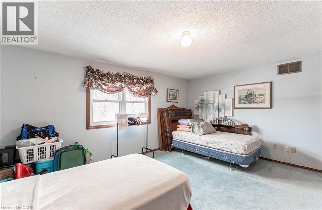 Carpeted bedroom featuring a textured ceiling and baseboards - 5 Charing Drive, Hamilton, ON - Indoor Photo Showing Bedroom