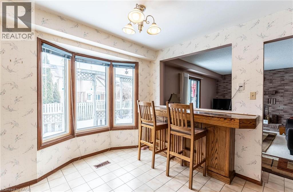 Bar featuring wallpapered walls and hanging lights - 5 Charing Drive, Hamilton, ON - Indoor Photo Showing Dining Room