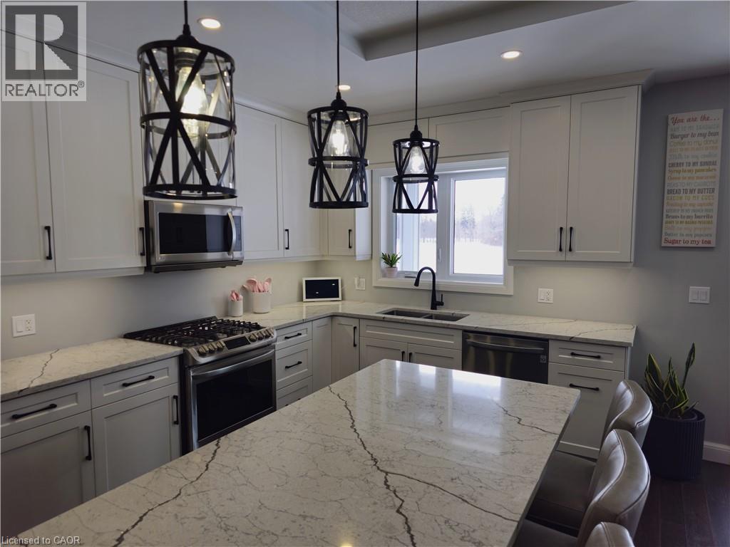 Quartz Countertops, Gas Stove, modern fixtures throughout - 46 Stonebridge Place, Simcoe, ON - Indoor Photo Showing Kitchen With Double Sink With Upgraded Kitchen