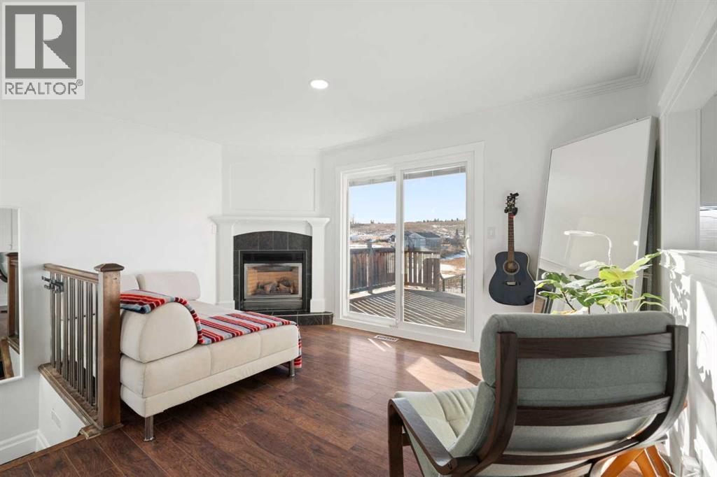 111 Macleod Trail E, Rural Foothills County, AB - Indoor Photo Showing Living Room With Fireplace