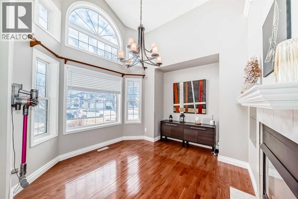 Den with large windows - 188 Hidden Ranch Crescent Nw, Calgary, AB - Indoor Photo Showing Other Room