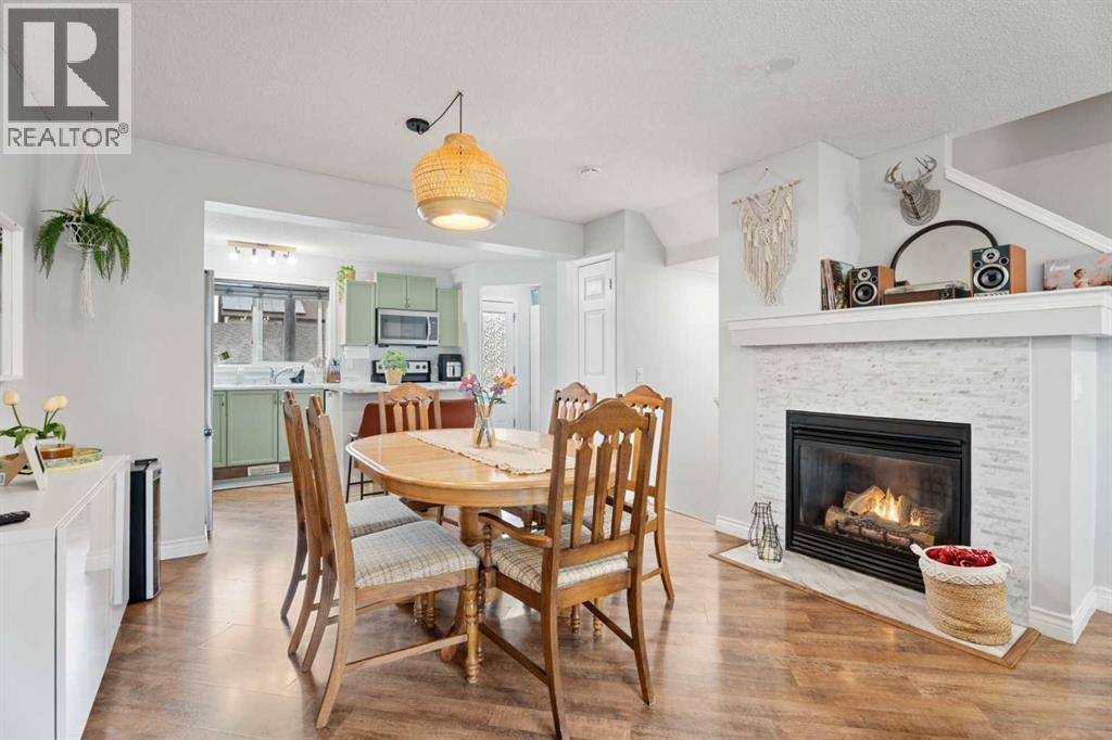 242 Elgin Place Se, Calgary, AB - Indoor Photo Showing Dining Room With Fireplace