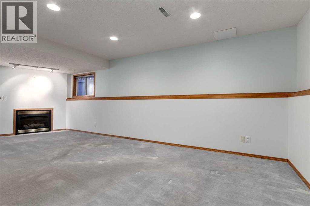 20 Willowbrook Gate Nw, Airdrie, AB - Indoor Photo Showing Other Room With Fireplace