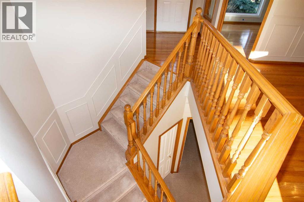 Let's walk down.. - 16 Eagleview Heights Nw, Cochrane, AB - Indoor Photo Showing Other Room