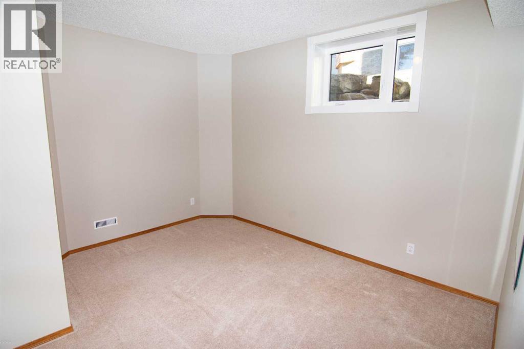 Guest Bed - Lower - 16 Eagleview Heights Nw, Cochrane, AB - Indoor Photo Showing Other Room