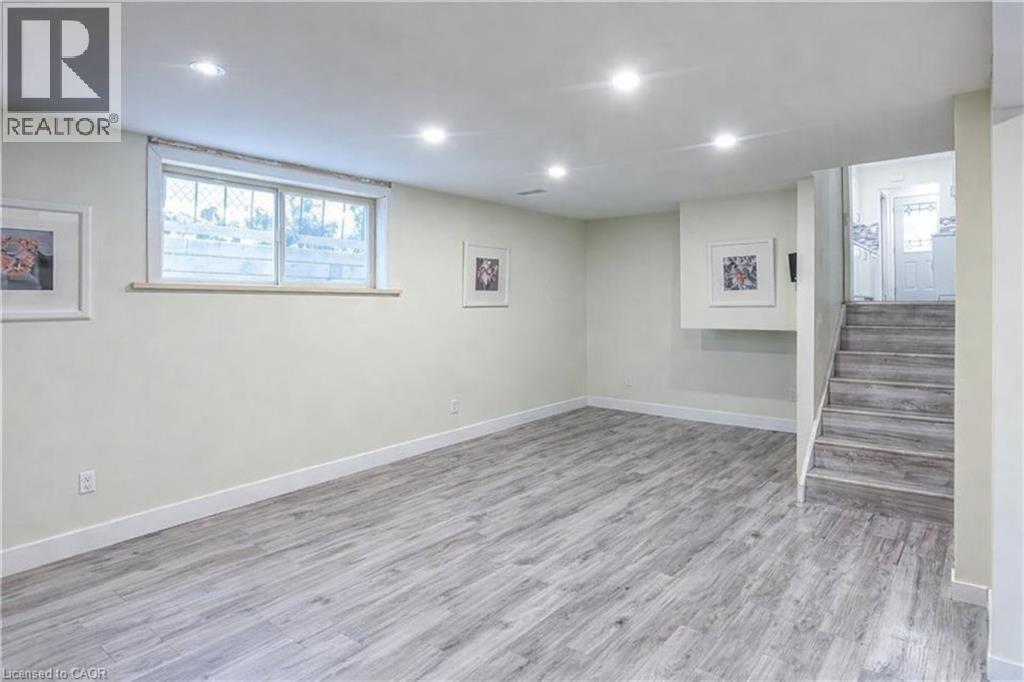 Basement with light wood-type flooring and recessed lighting - 310 Magnolia Drive, Hamilton, ON - Indoor