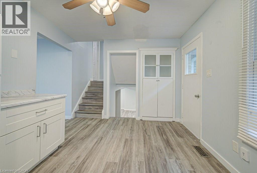 Unfurnished dining area with ceiling fan and light wood-style floors - 310 Magnolia Drive, Hamilton, ON