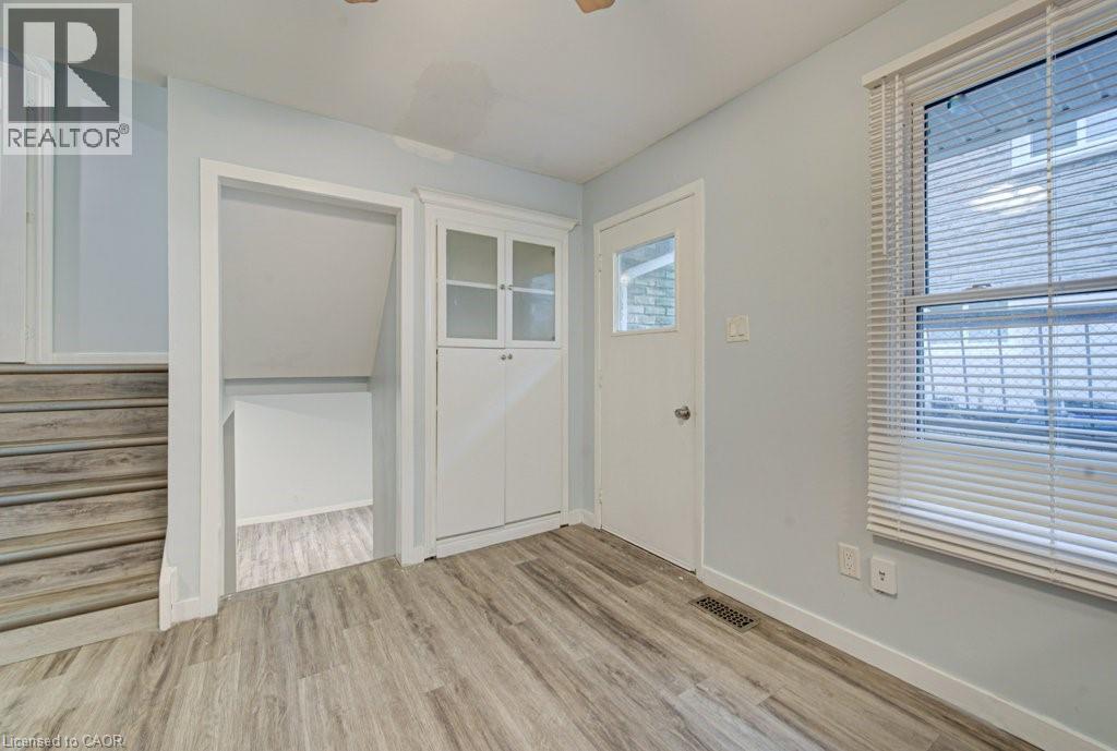 Foyer entrance featuring light wood-style flooring and ceiling fan - 310 Magnolia Drive, Hamilton, ON