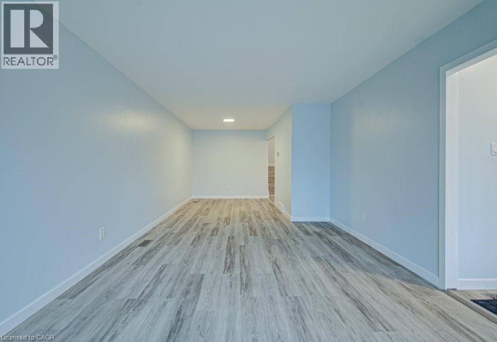 Unfurnished room with light wood-type flooring and recessed lighting - 310 Magnolia Drive, Hamilton, ON
