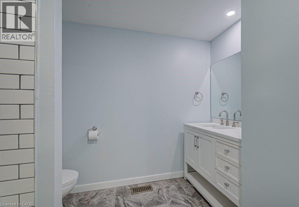 Bathroom featuring vanity and recessed lighting - 310 Magnolia Drive, Hamilton, ON