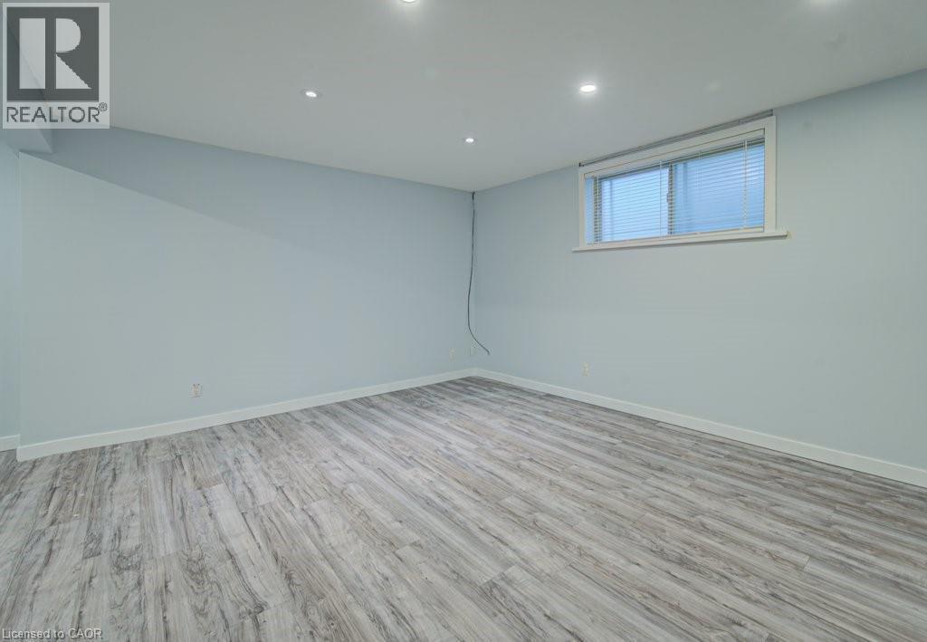 Below grade area featuring light wood-type flooring and recessed lighting - 310 Magnolia Drive, Hamilton, ON