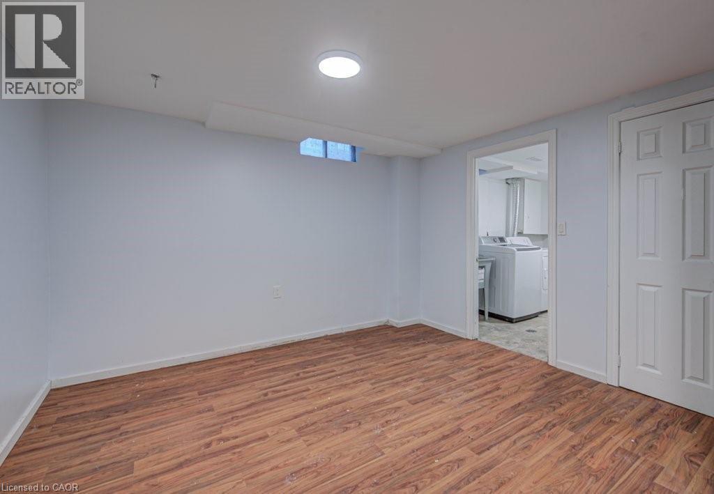 Finished basement featuring light wood finished floors and baseboards - 310 Magnolia Drive, Hamilton, ON