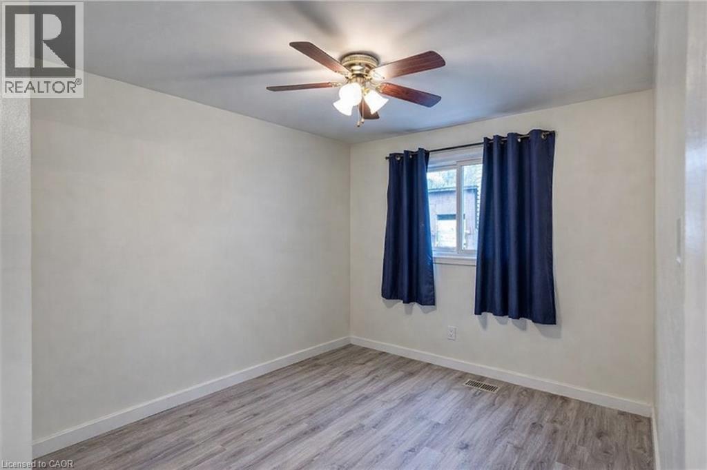 Spare room featuring wood finished floors and ceiling fan - 310 Magnolia Drive, Hamilton, ON - Indoor Photo Showing Other Room
