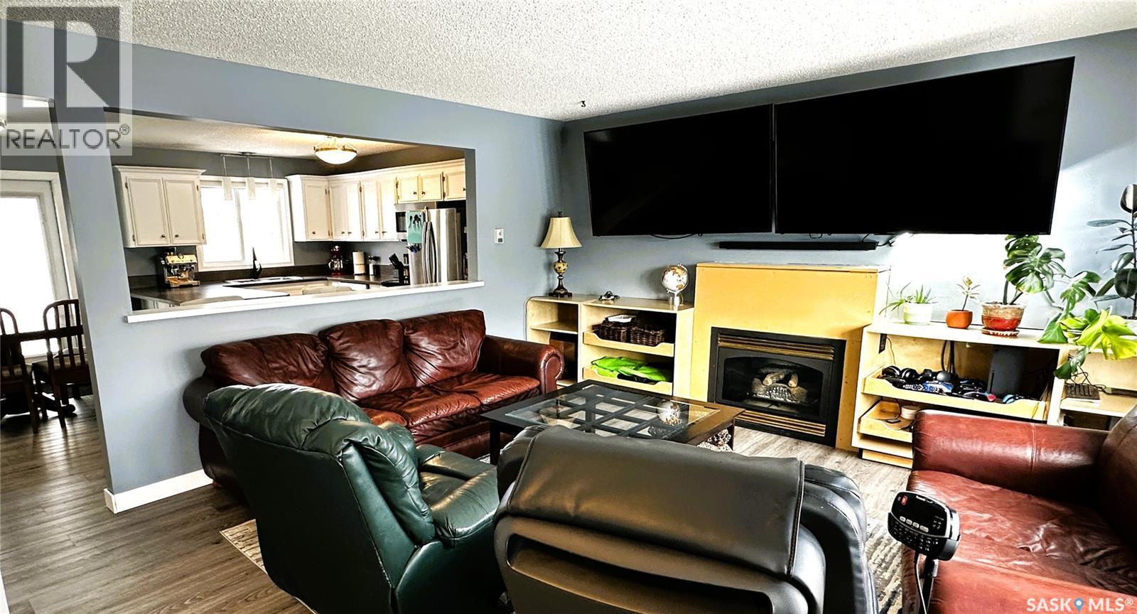 131 Dunsmore Drive, Regina, SK - Indoor Photo Showing Living Room With Fireplace
