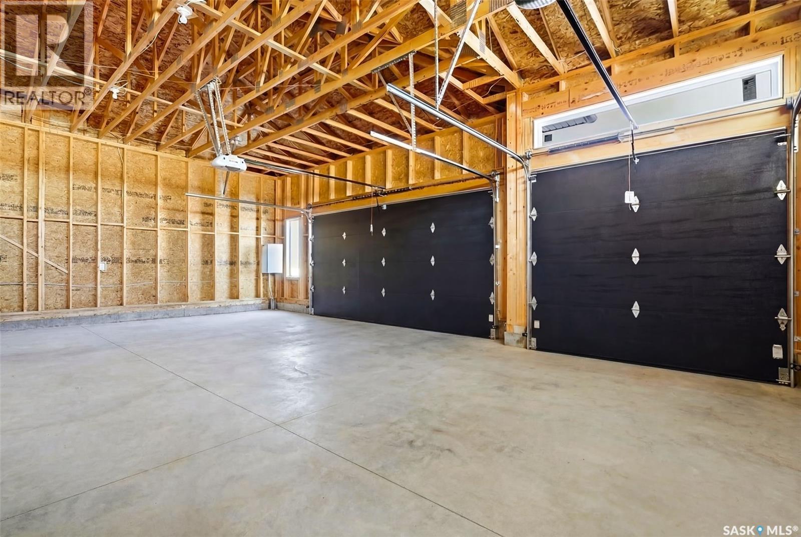 13 Plains Green, Pilot Butte, SK - Indoor Photo Showing Garage