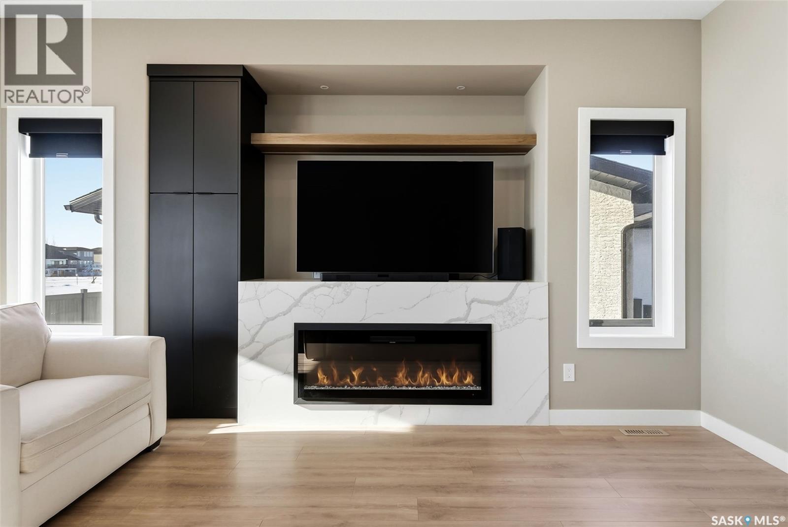 13 Plains Green, Pilot Butte, SK - Indoor Photo Showing Living Room With Fireplace