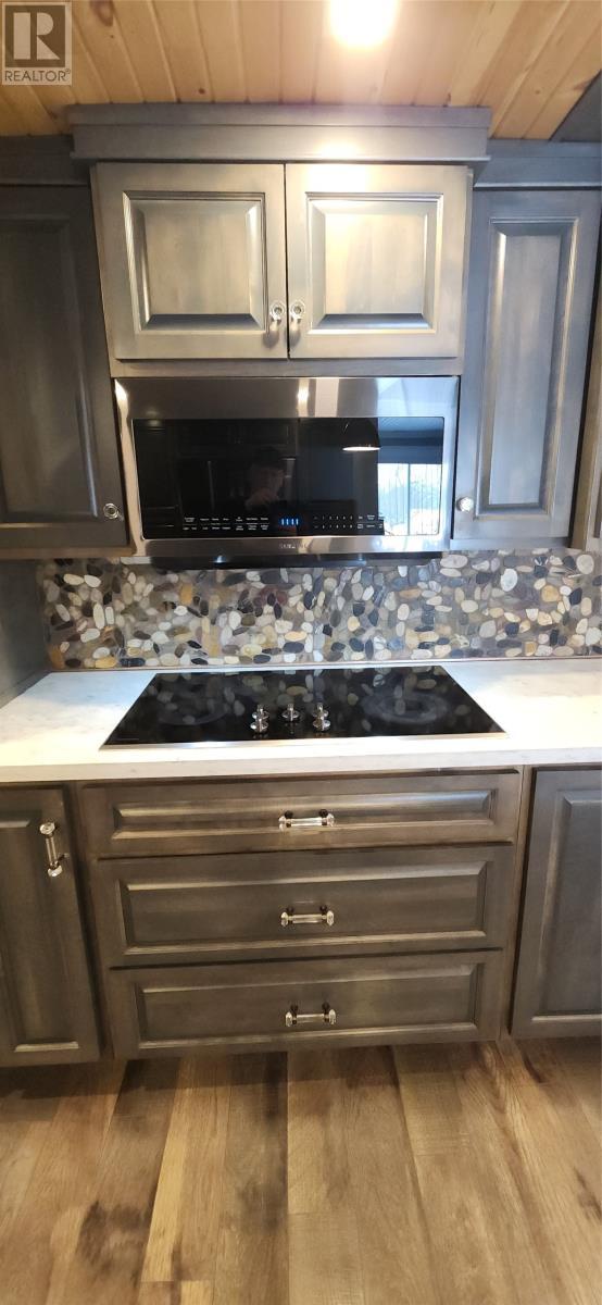 Stove top and built in microwave - 15 Squires Road, Eastport, NL - Indoor Photo Showing Kitchen With Upgraded Kitchen