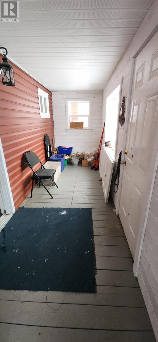 There is a generator panel in the house and a generator in the sunporch - 15 Squires Road, Eastport, NL - Photo Showing Other Room