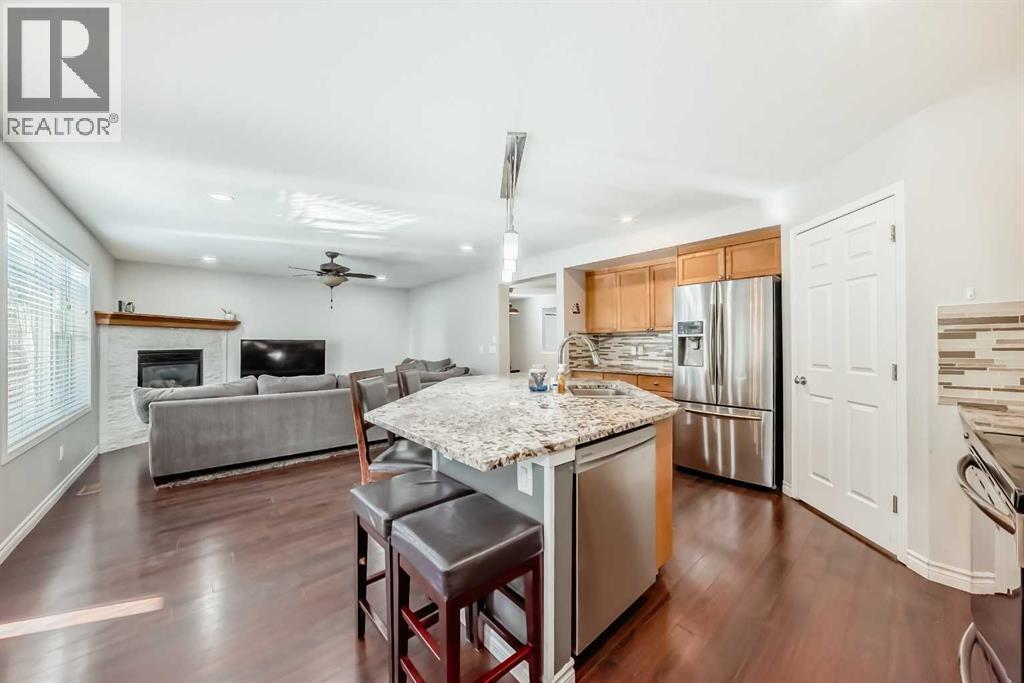 574 Chaparral Drive Se, Calgary, AB - Indoor Photo Showing Kitchen With Fireplace With Stainless Steel Kitchen With Upgraded Kitchen