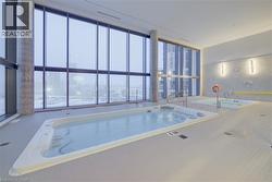 View of swimming pool featuring a sunroom -