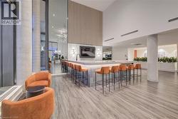 Bar area featuring a high ceiling and modern cabinets -