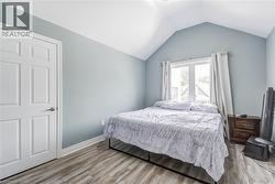 Bedroom featuring light wood finished floors and baseboards -