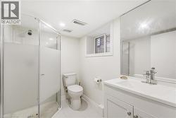 Full bathroom with vanity, a shower stall, and light tile patterned floors -