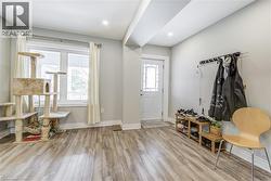 Foyer entrance with light wood finished floors and recessed lighting -
