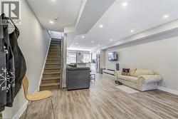 Living room featuring light wood-style flooring and recessed lighting -