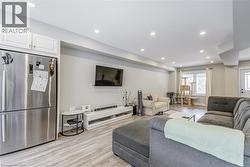 Living room with recessed lighting and light wood-style floors -