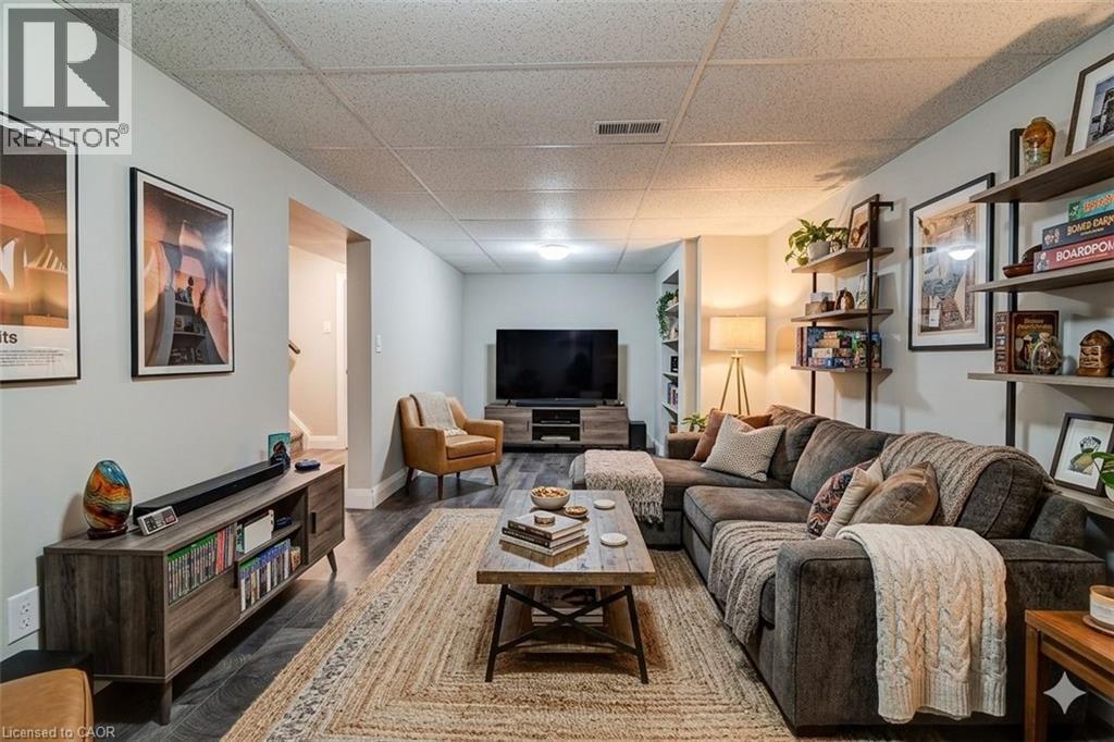 Living area featuring a paneled ceiling and dark wood finished floors - 417 Garden Street, Cambridge, ON - Indoor Photo Showing Living Room