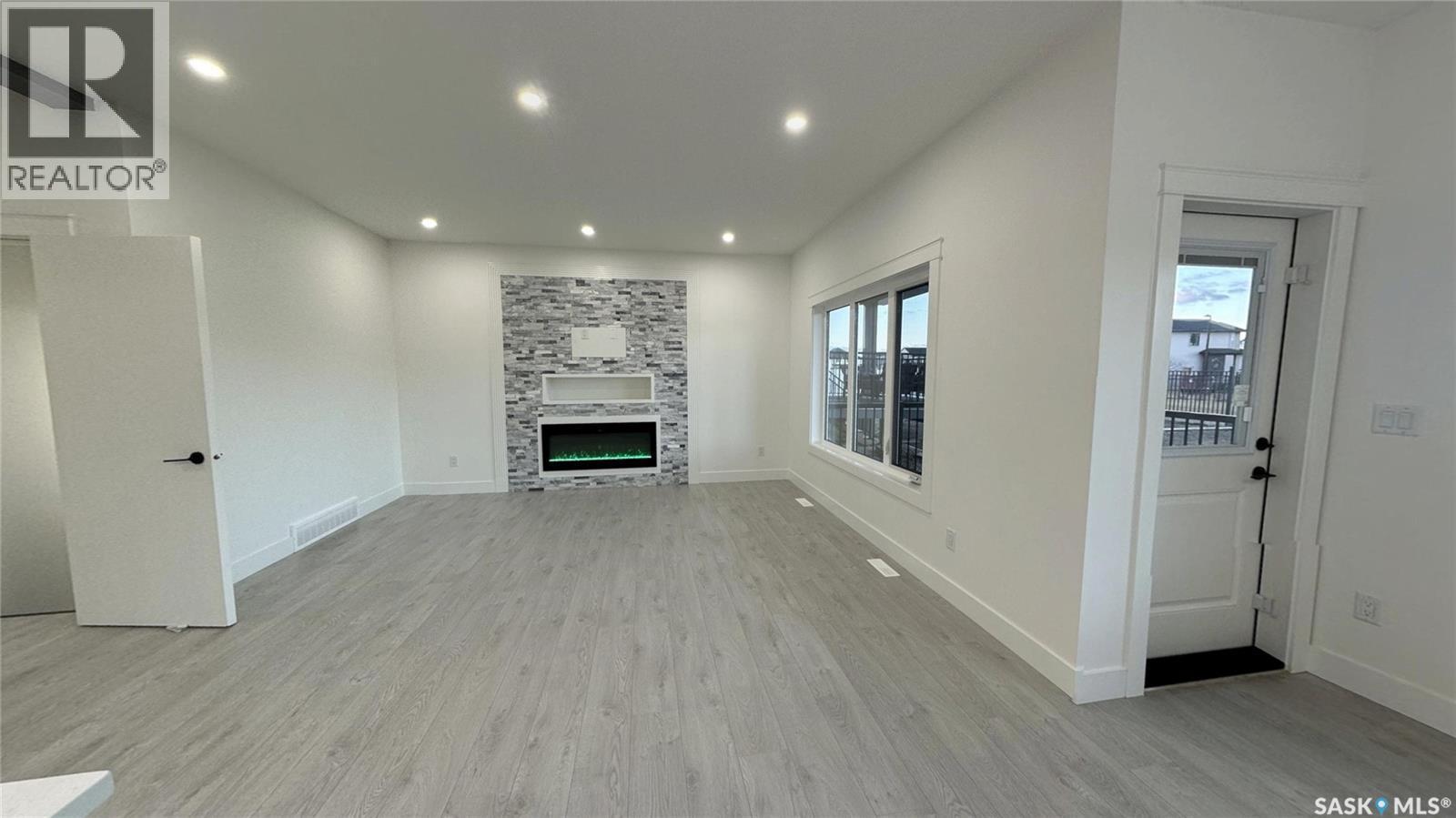 147 Woolf Bend, Saskatoon, SK - Indoor With Fireplace