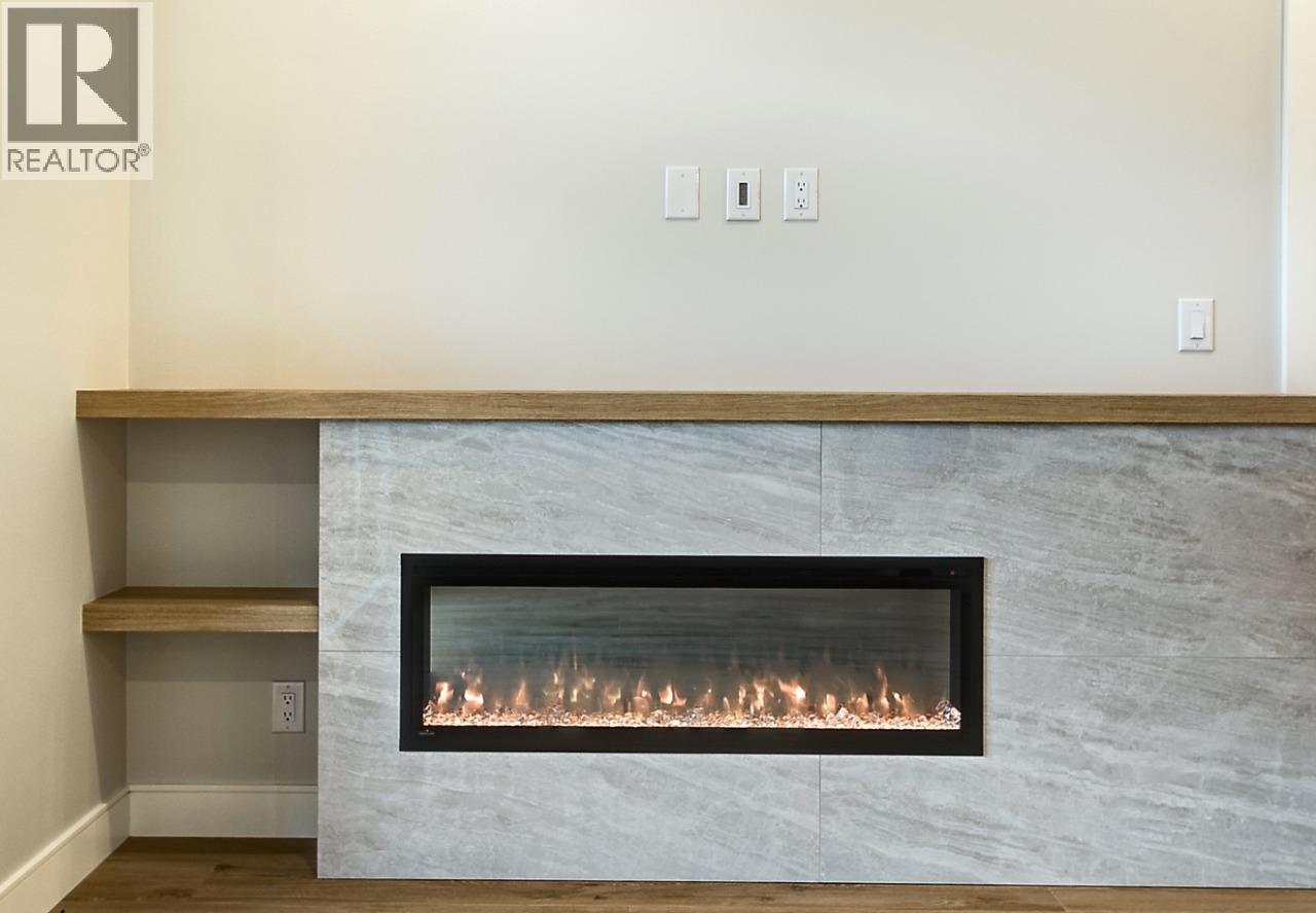 75 Predator Ridge Drive Unit# 205, Vernon, BC - Indoor With Fireplace