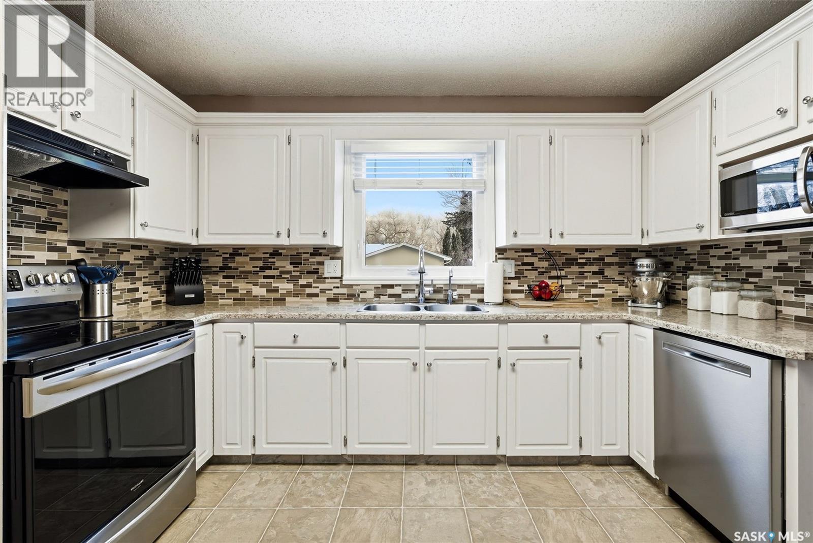 63 Champ Crescent, Regina, SK - Indoor Photo Showing Kitchen With Stainless Steel Kitchen With Double Sink