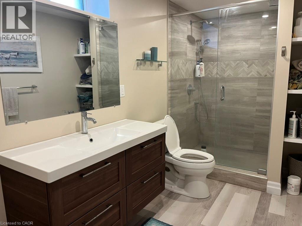 Bathroom with vanity, light wood-style flooring, and a stall shower - 235 Fearnwood Street, Cambridge, ON - Indoor Photo Showing Bathroom