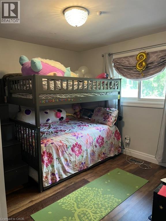 Bedroom with dark wood finished floors and baseboards - 235 Fearnwood Street, Cambridge, ON - Indoor Photo Showing Bedroom