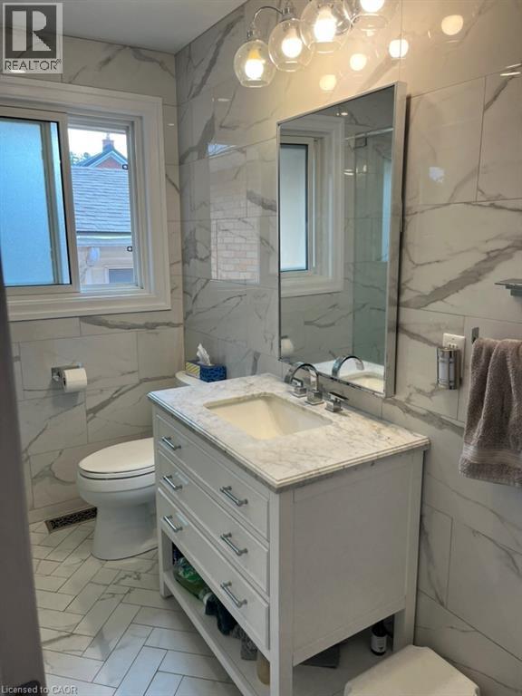 Bathroom featuring tile walls, vanity, and light marble finish flooring - 235 Fearnwood Street, Cambridge, ON - Indoor Photo Showing Bathroom